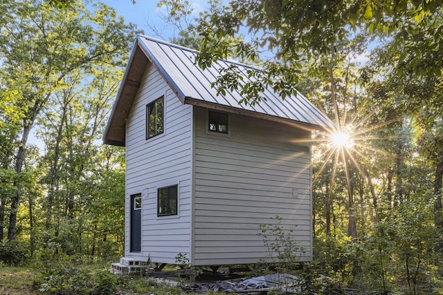 view of side of home with metal roof and a standing seam roof