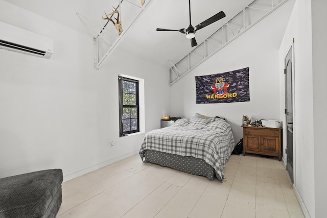 bedroom with a ceiling fan, an AC wall unit, wood finished floors, high vaulted ceiling, and baseboards