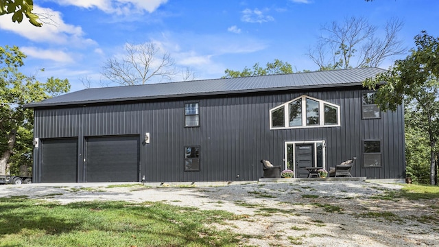 exterior space with metal roof and driveway