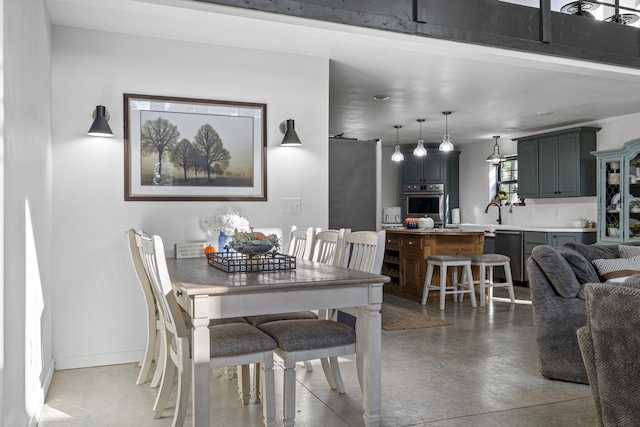 dining space with finished concrete flooring