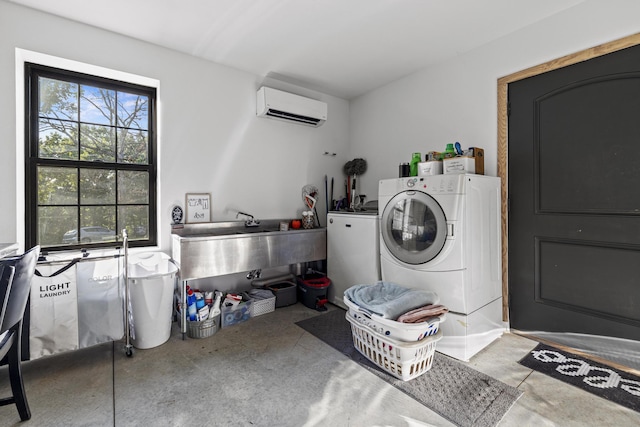 clothes washing area with laundry area, washer and clothes dryer, and a wall mounted air conditioner