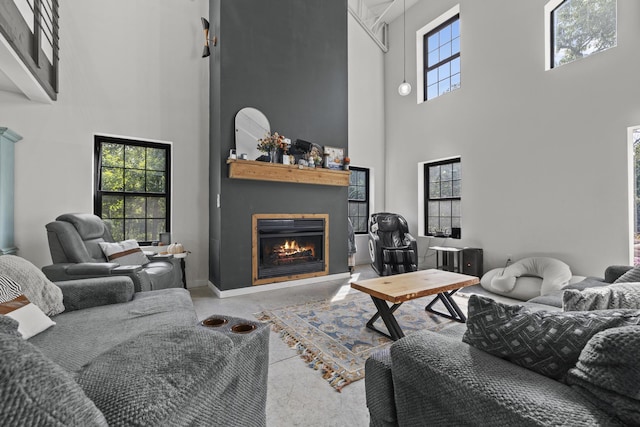 living area featuring a fireplace and finished concrete flooring