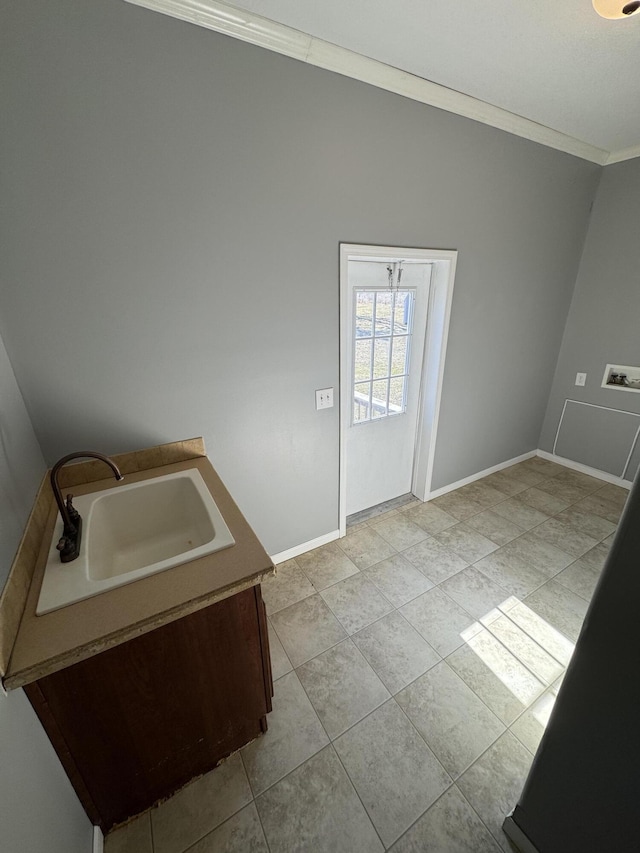 laundry area with washer hookup, crown molding, light tile patterned floors, a sink, and baseboards