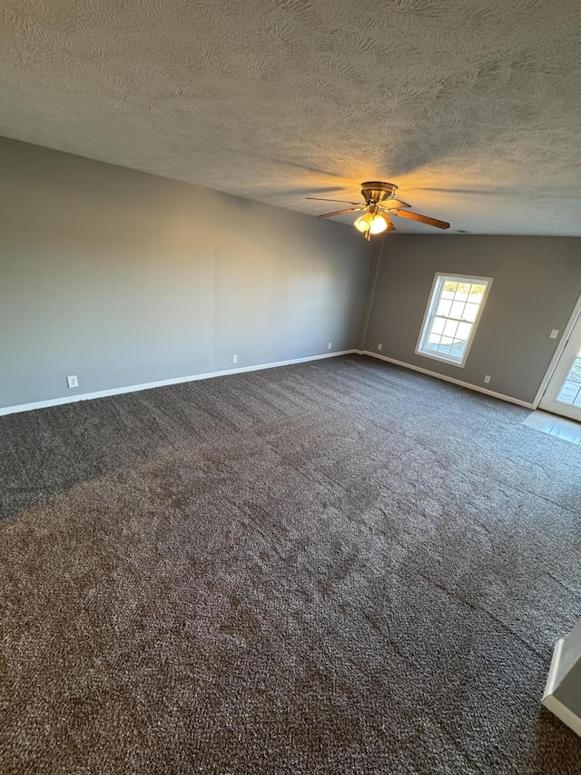 unfurnished room featuring a ceiling fan, a textured ceiling, baseboards, and carpet flooring