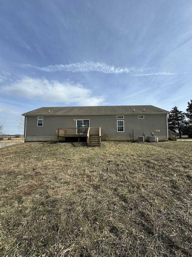 back of property featuring a wooden deck