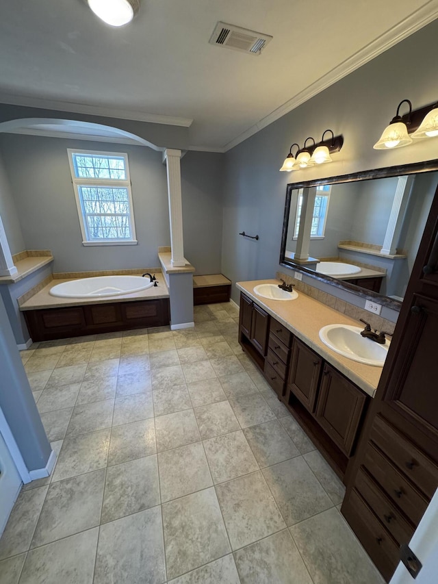 bathroom featuring crown molding, a wealth of natural light, visible vents, and a sink