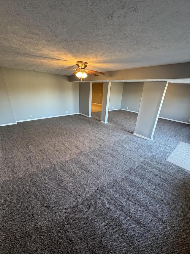 unfurnished bedroom with baseboards, carpet, a ceiling fan, and a textured ceiling