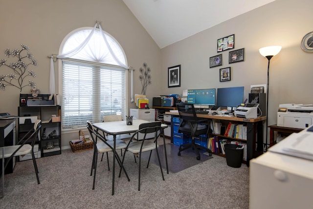 carpeted home office with vaulted ceiling