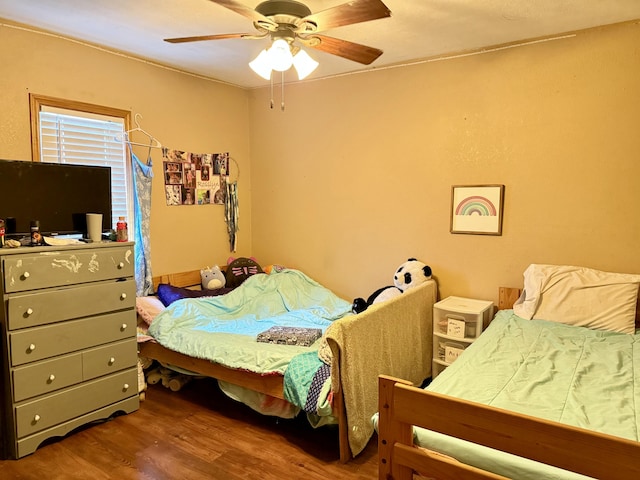 bedroom featuring a ceiling fan and wood finished floors