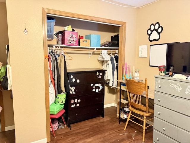 interior space featuring baseboards and wood finished floors