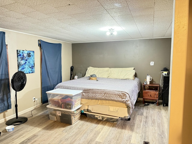 bedroom featuring wood finished floors and baseboards