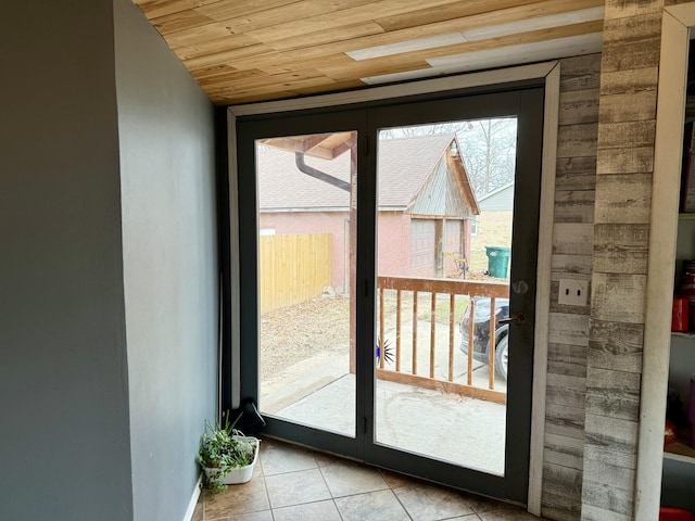 doorway featuring tile patterned flooring and wooden ceiling