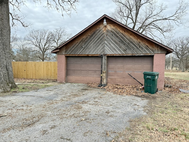 detached garage featuring fence