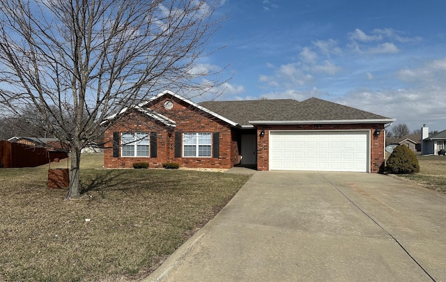 single story home with driveway, a front lawn, an attached garage, and brick siding