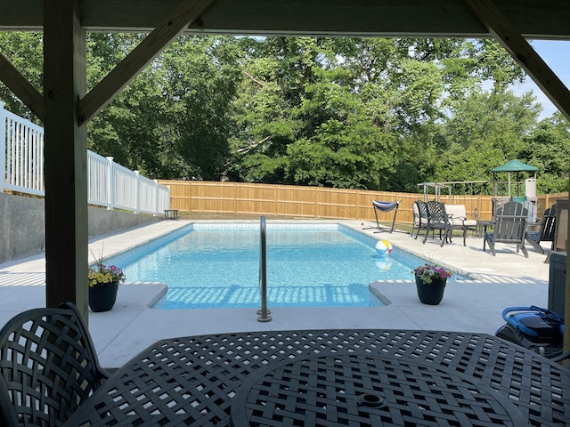 view of swimming pool with a patio, a fenced backyard, and a fenced in pool