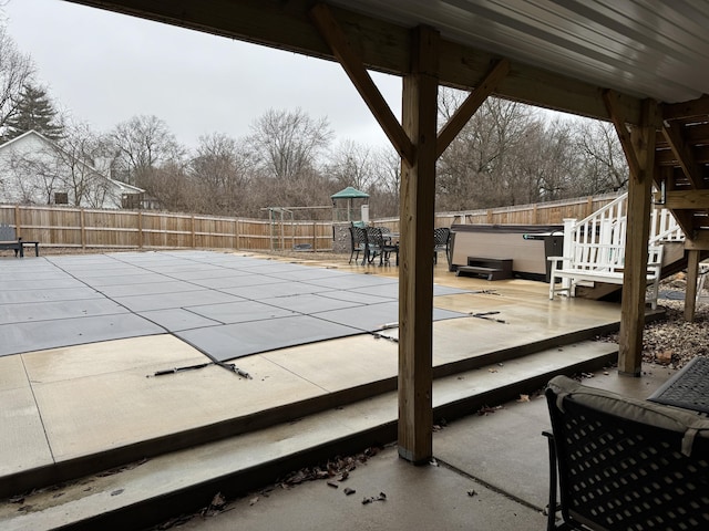 view of swimming pool featuring a fenced backyard, a patio, and a hot tub