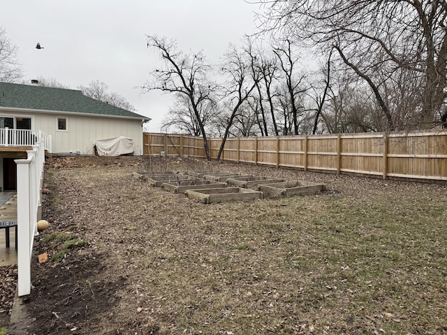 view of yard featuring fence private yard and a garden