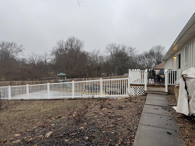 view of yard with a fenced backyard and a wooden deck