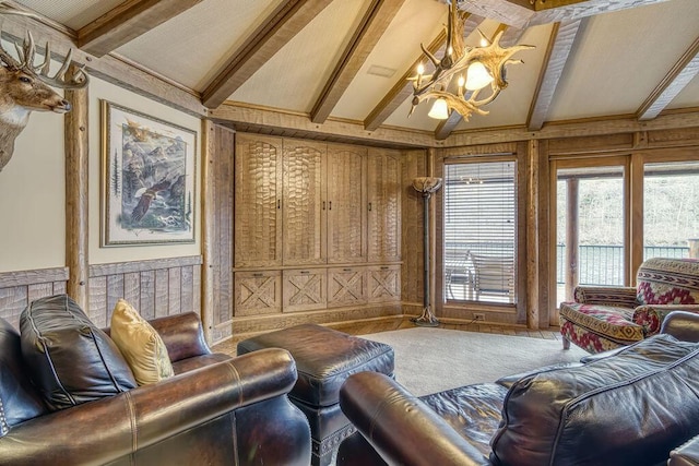 carpeted living room featuring vaulted ceiling with beams and an inviting chandelier