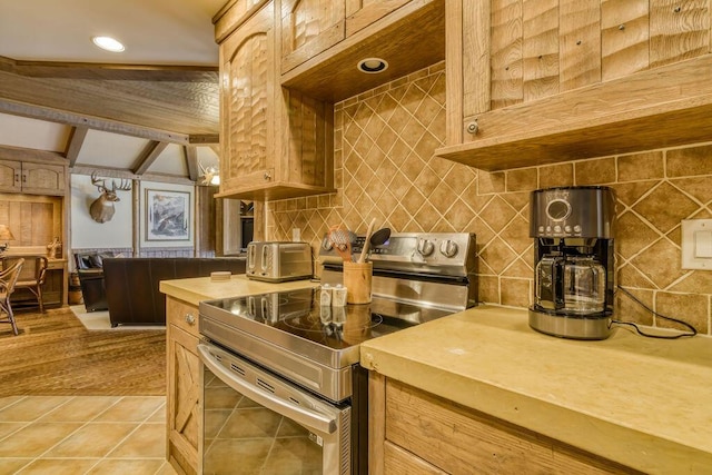 kitchen featuring light tile patterned floors, stainless steel electric range oven, a toaster, and tasteful backsplash