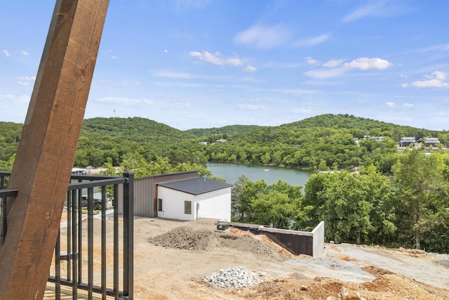 property view of water featuring a forest view