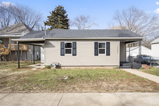 view of front facade with covered porch, a shingled roof, a carport, and a front yard