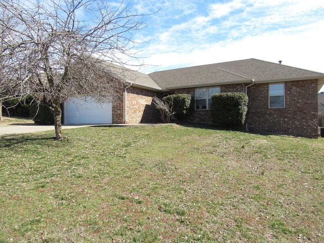 ranch-style house with a garage, brick siding, driveway, and a front lawn