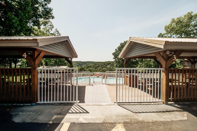 exterior space featuring a gazebo, fence, and a fenced in pool