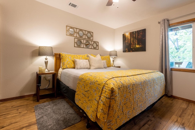 bedroom featuring baseboards, visible vents, and hardwood / wood-style floors