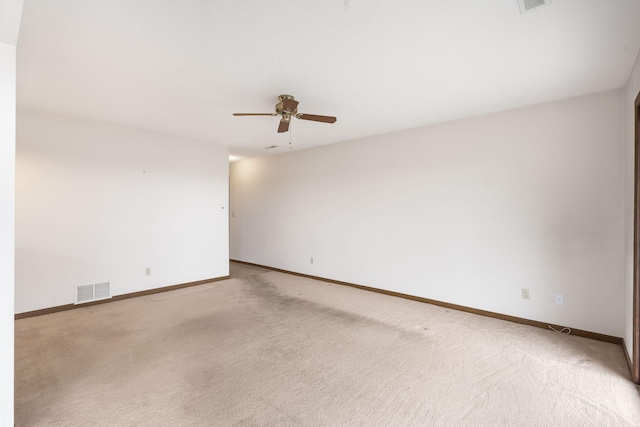 empty room with carpet floors, baseboards, and visible vents