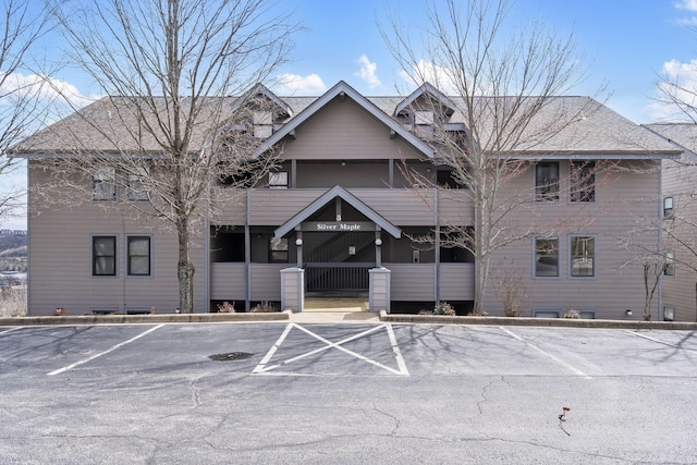 view of property featuring uncovered parking