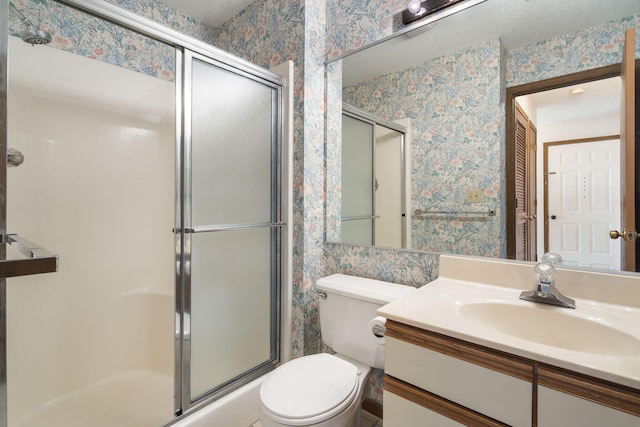 full bathroom with a textured ceiling, vanity, a shower with door, and wallpapered walls