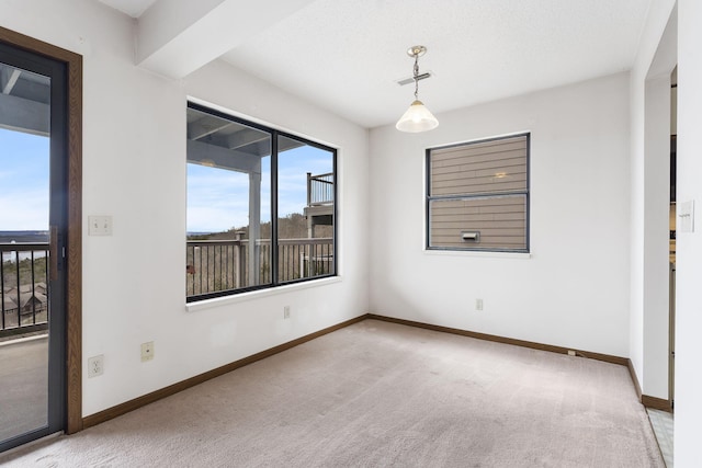 unfurnished room featuring carpet floors, visible vents, and baseboards