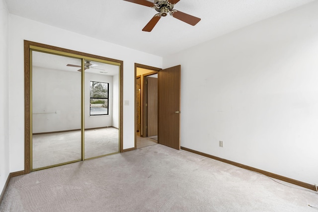 unfurnished bedroom with a ceiling fan, a closet, carpet flooring, and baseboards