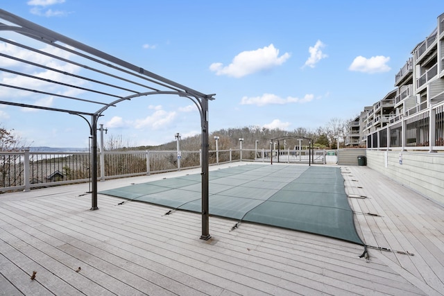 pool featuring fence and a pergola