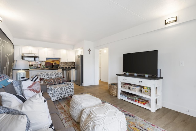 living room featuring wood finished floors and baseboards