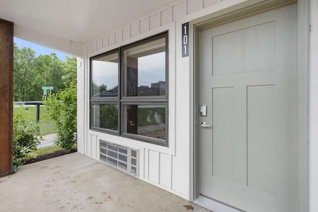 doorway to property featuring board and batten siding