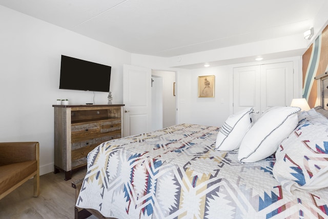 bedroom featuring a closet and wood finished floors