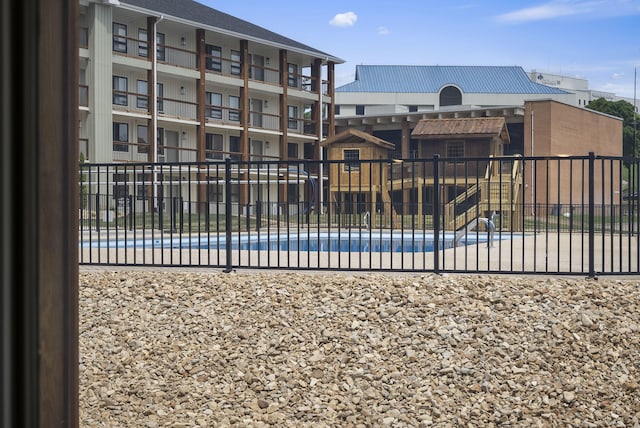 view of swimming pool featuring fence