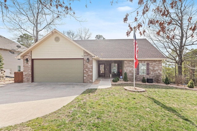 view of front facade with a garage, driveway, a front lawn, and brick siding