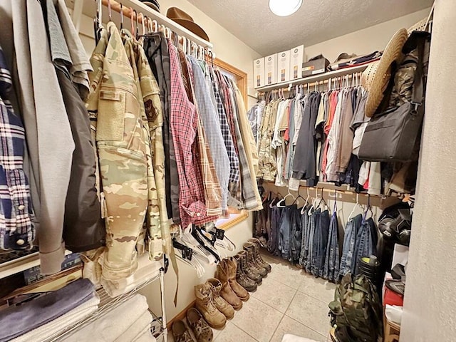 walk in closet with tile patterned flooring