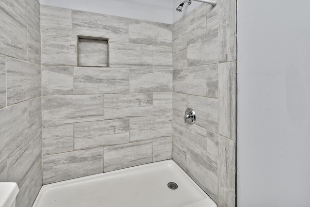 bathroom with tiled shower