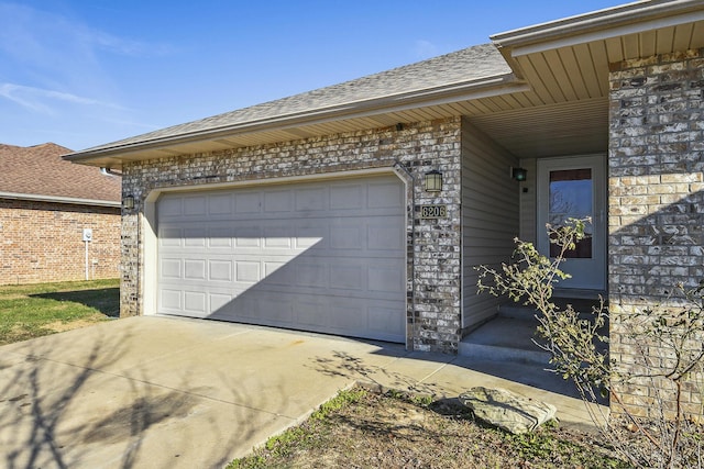 garage featuring concrete driveway