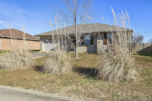 view of front of property with a garage, fence, and brick siding