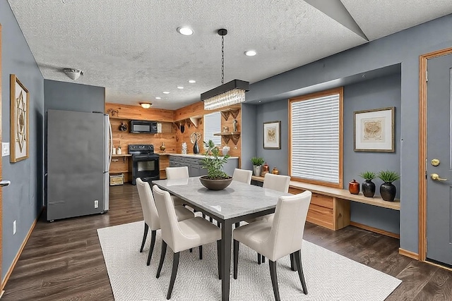 dining space featuring recessed lighting, dark wood finished floors, a textured ceiling, and baseboards