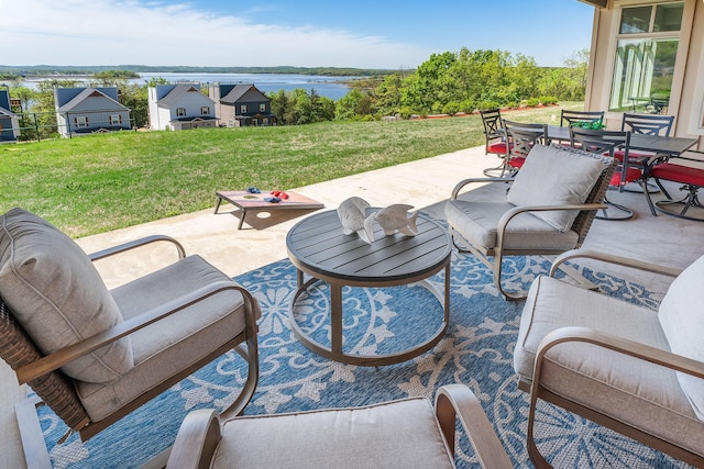 view of patio featuring a water view and outdoor dining space