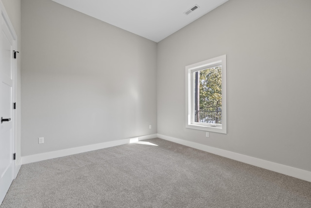 unfurnished room with carpet floors, baseboards, and visible vents