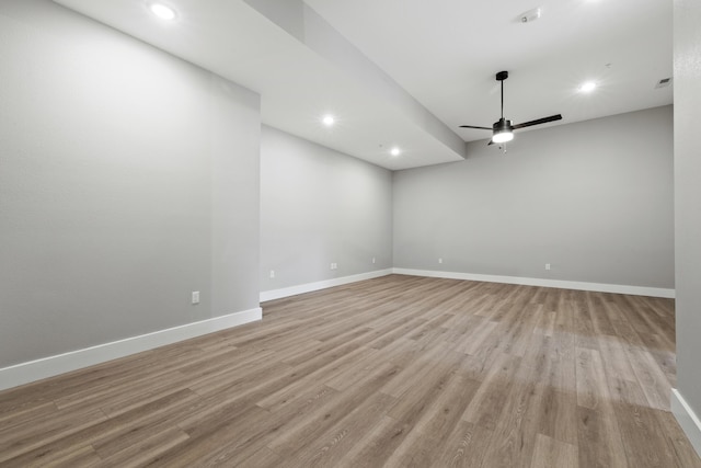 empty room featuring light wood-style floors, baseboards, a ceiling fan, and recessed lighting