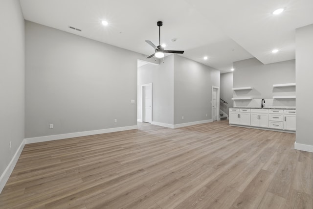 unfurnished living room featuring recessed lighting, visible vents, ceiling fan, light wood-type flooring, and baseboards