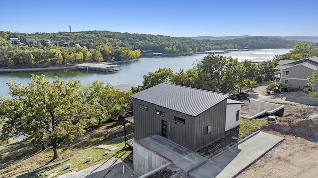 aerial view featuring a water view and a wooded view